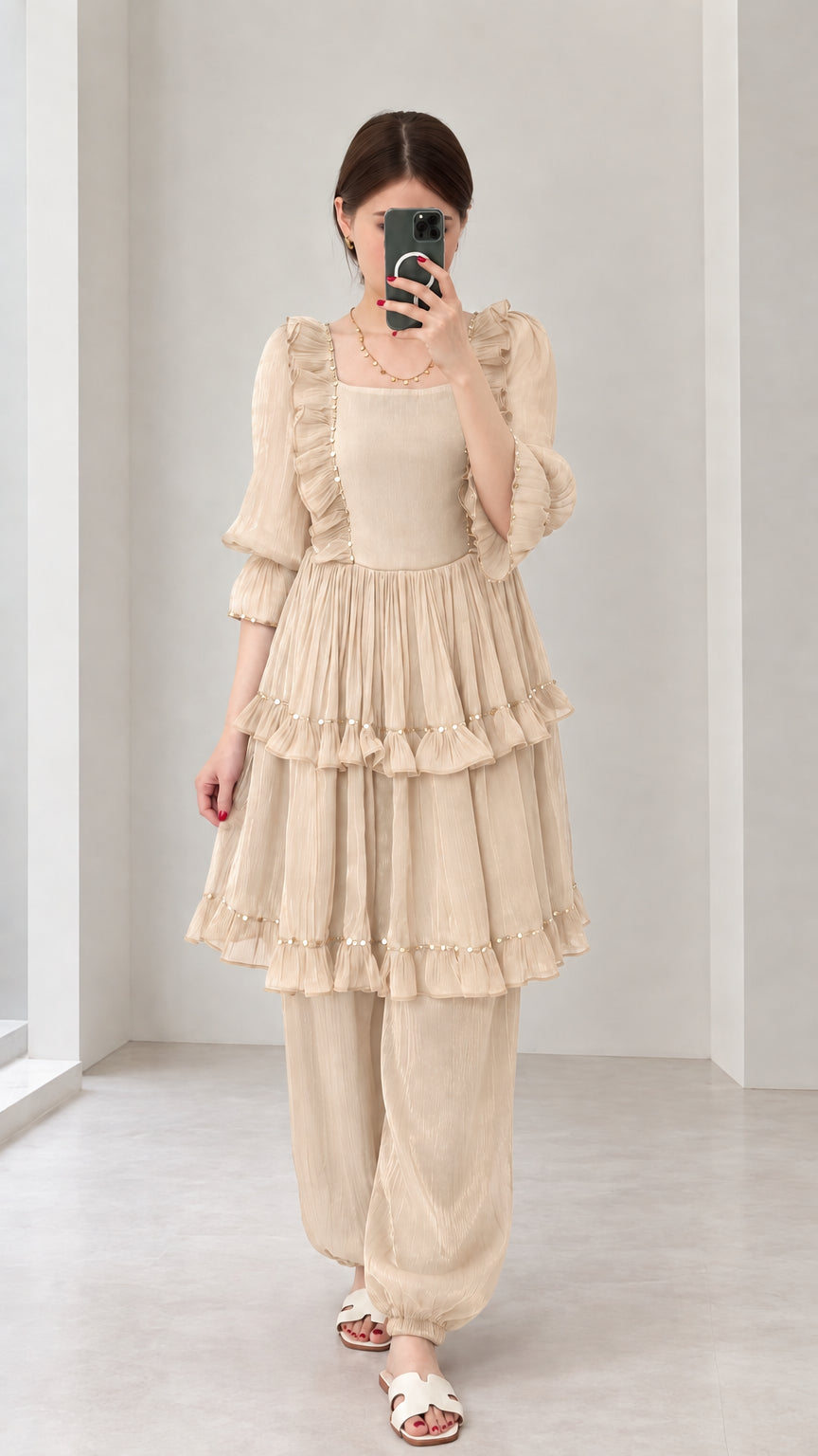 Front view of woman wearing Beige tiered ruffle tunic top and harem pant set