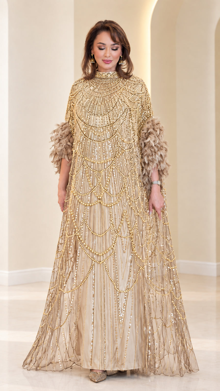 Champagne gold embellished cape maxi gown with feather trim