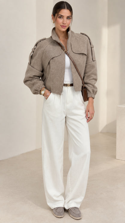 Taupe cropped stand collar utility jacket front view on model with white wide-leg trousers