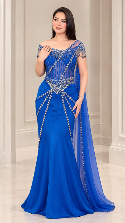 Front view of model wearing Royal Blue off-the-shoulder beaded mermaid evening gown with sheer drape