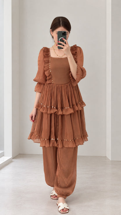 Front view of woman wearing Rust Brown tiered ruffle tunic and harem pant two-piece set