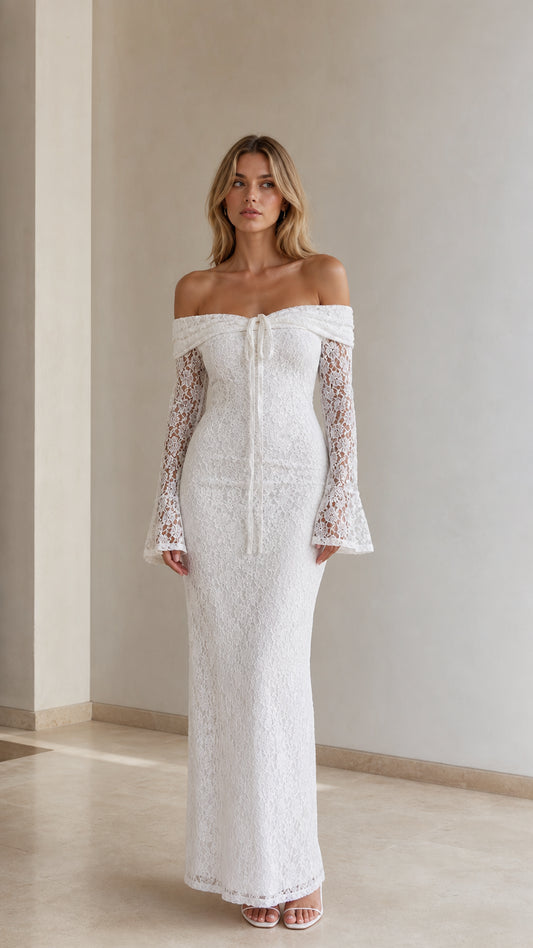 Front view of woman wearing white off-the-shoulder lace maxi dress with long bell sleeves