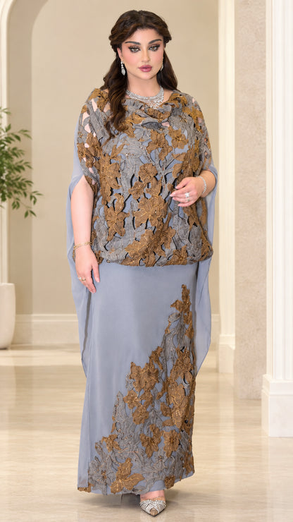 Front view of model wearing dusty blue embroidered lace cape maxi evening gown