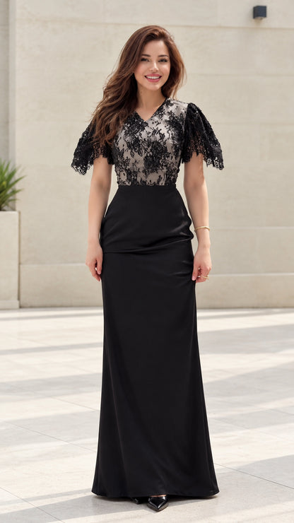 Front view of model wearing black floral lace flutter sleeve maxi evening gown
