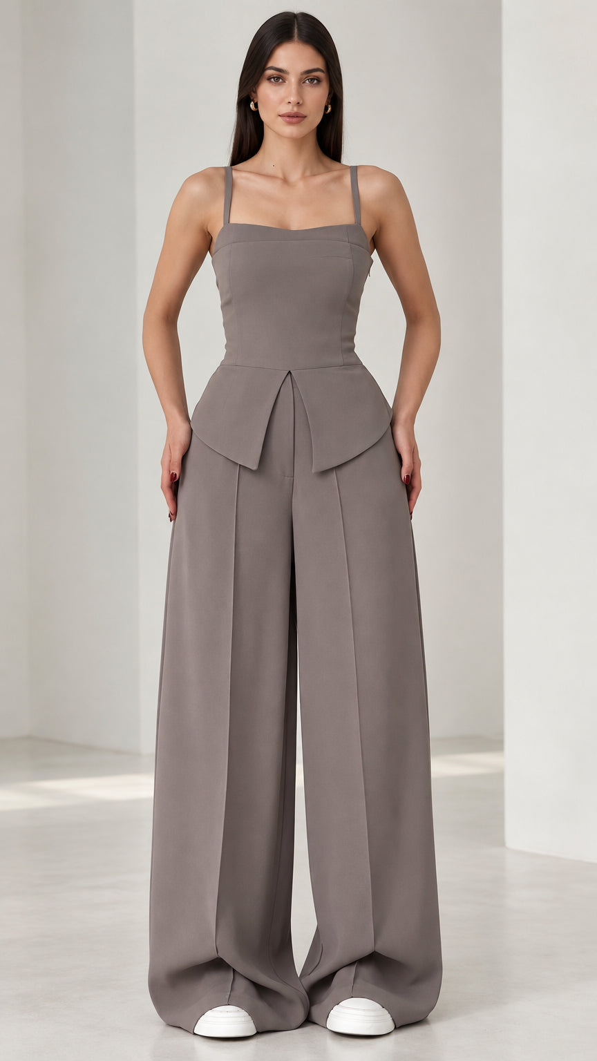 Full front view of model wearing grey square neck peplum wide leg jumpsuit