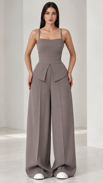 Full front view of model wearing grey square neck peplum wide leg jumpsuit
