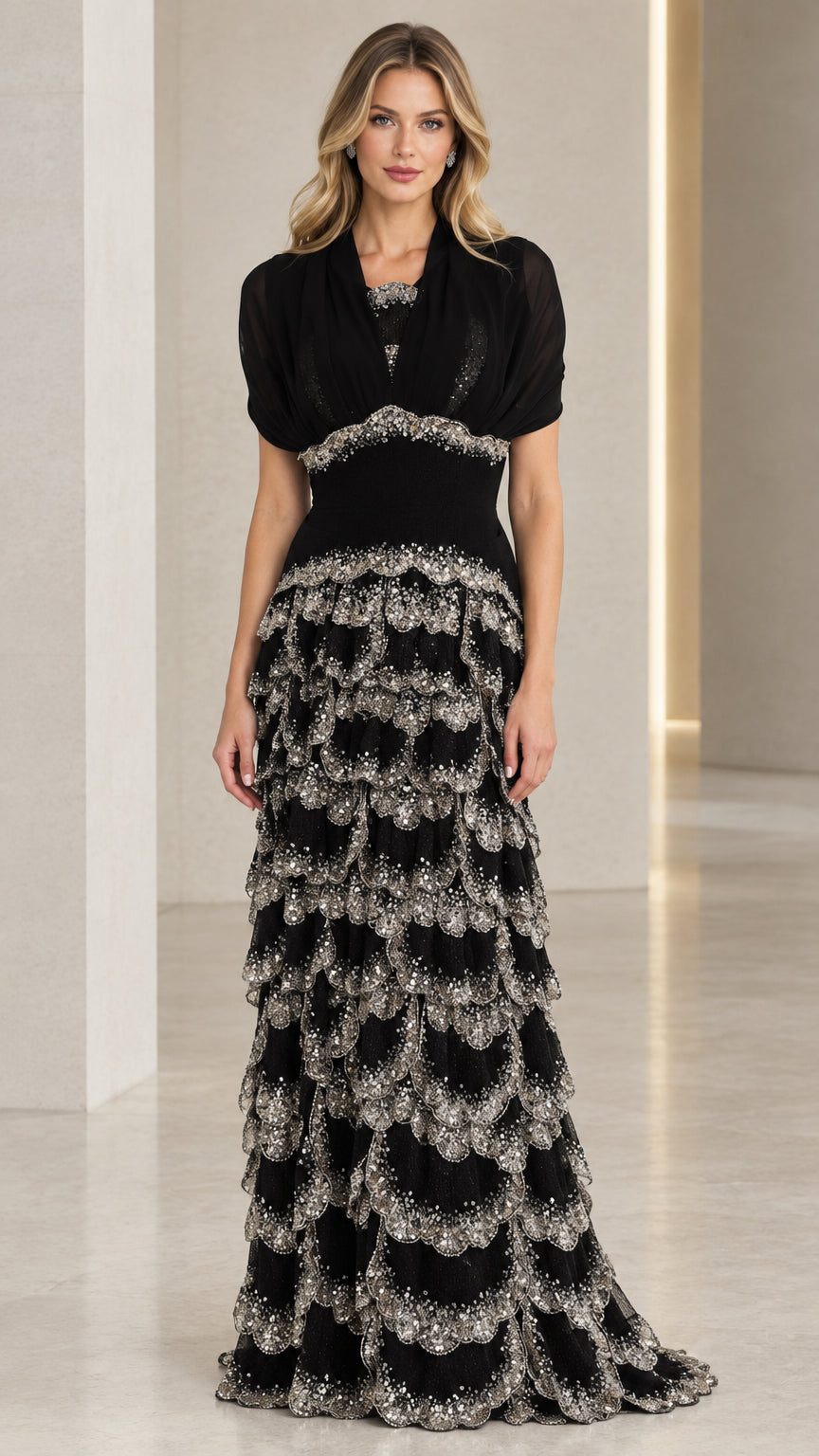 Front full view of black sequined tiered evening gown with draped bodice