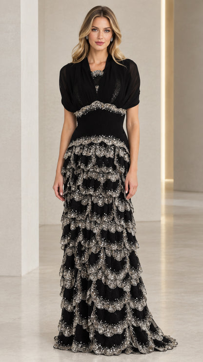 Front full view of black sequined tiered evening gown with draped bodice