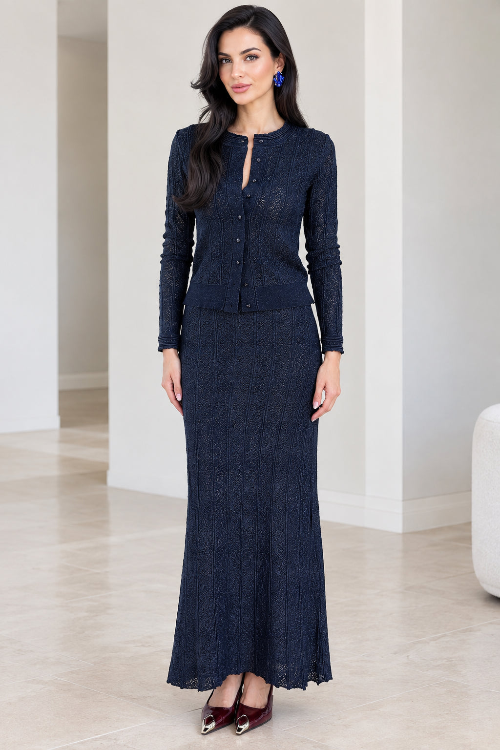 Front view of woman wearing navy blue textured knit cardigan and maxi skirt set
