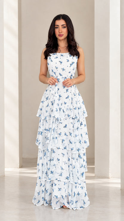 Front view of model wearing white floral tiered spaghetti strap maxi dress