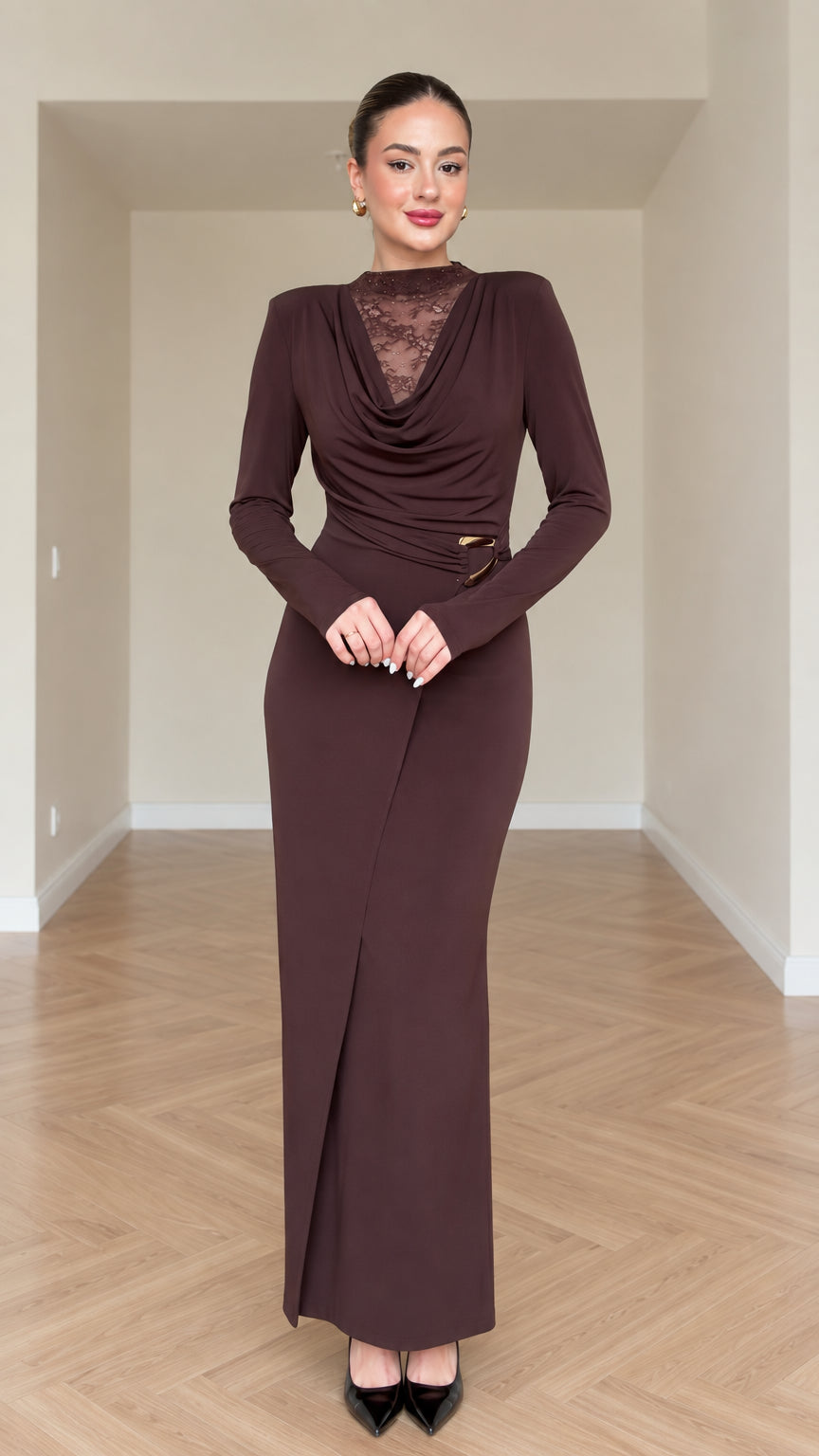 Front view of model wearing chocolate brown draped cowl neck maxi dress with lace insert