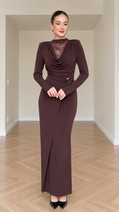 Front view of model wearing chocolate brown draped cowl neck maxi dress with lace insert