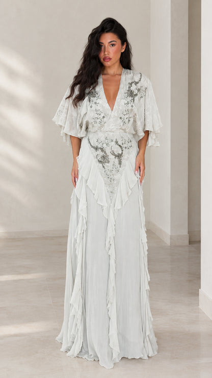Front view of woman wearing elegant ice blue embroidered flutter sleeve maxi dress