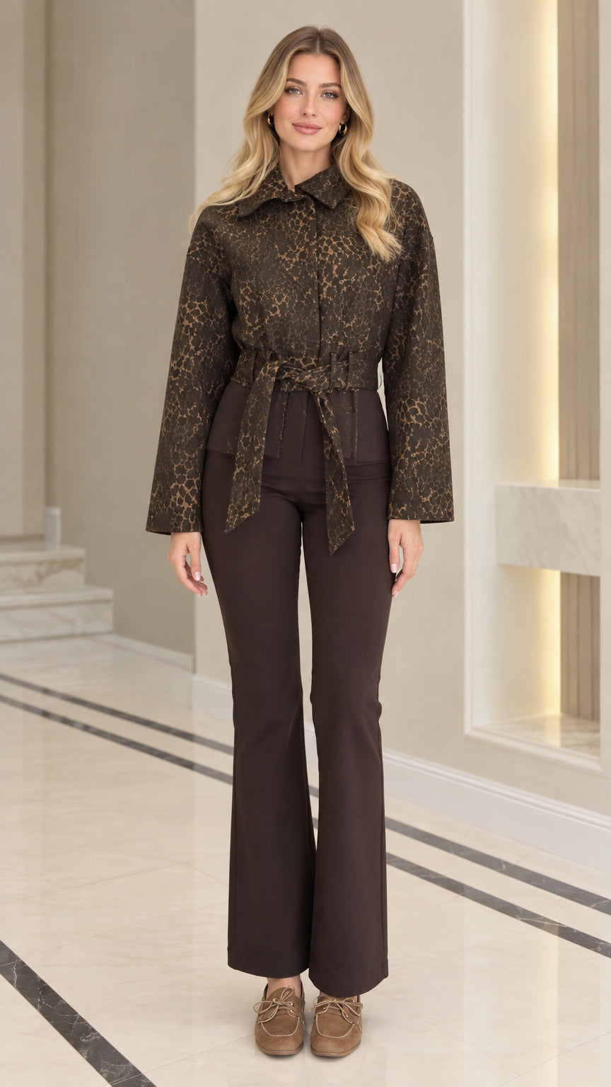 Full front view of model wearing coffee brown textured jacquard belted jacket with brown flare pants