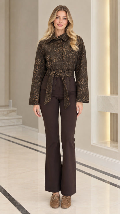 Full front view of model wearing coffee brown textured jacquard belted jacket with brown flare pants