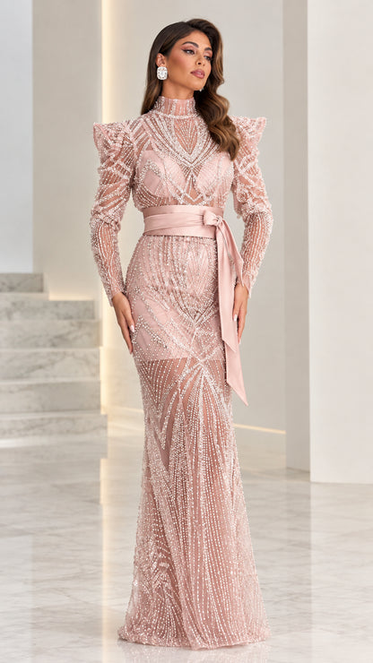 Front view of model wearing dusty pink high neck beaded evening gown with satin belt