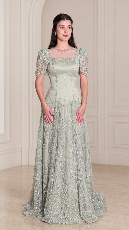 Front view of model wearing Sage Green beaded short sleeve evening gown