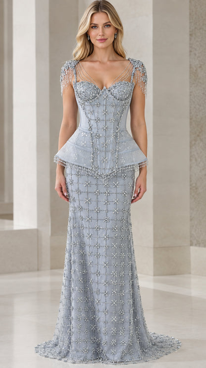 Front view of model wearing dusty blue beaded corset peplum evening gown