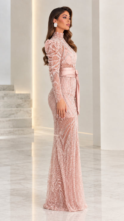 Side angle view of model in dusty pink embellished long-sleeve evening gown