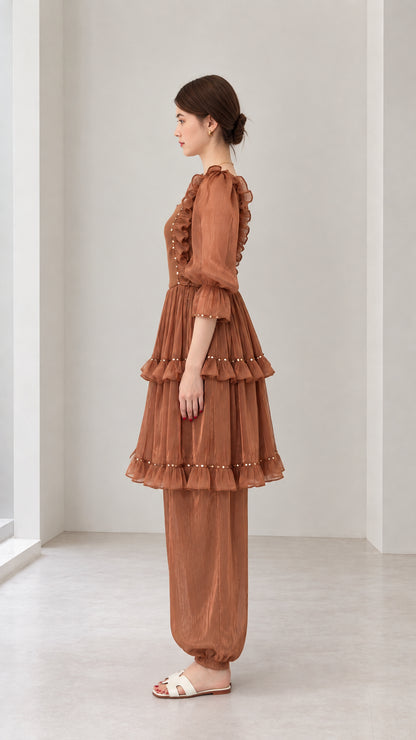 Side profile view of woman wearing Rust Brown tiered ruffle tunic top and pants set