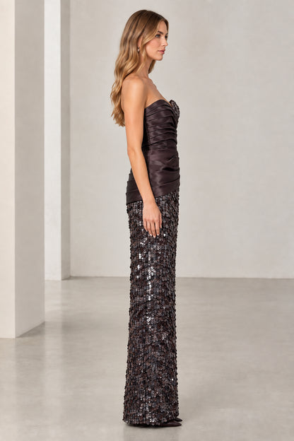 Side profile view of woman wearing strapless espresso brown evening maxi dress