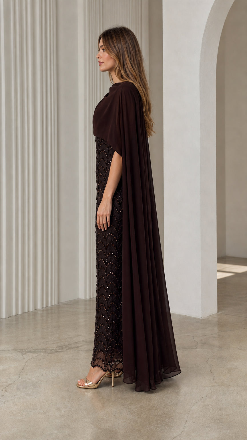 Side profile view of dark brown sequined evening gown showcasing sheer chiffon back cape drape