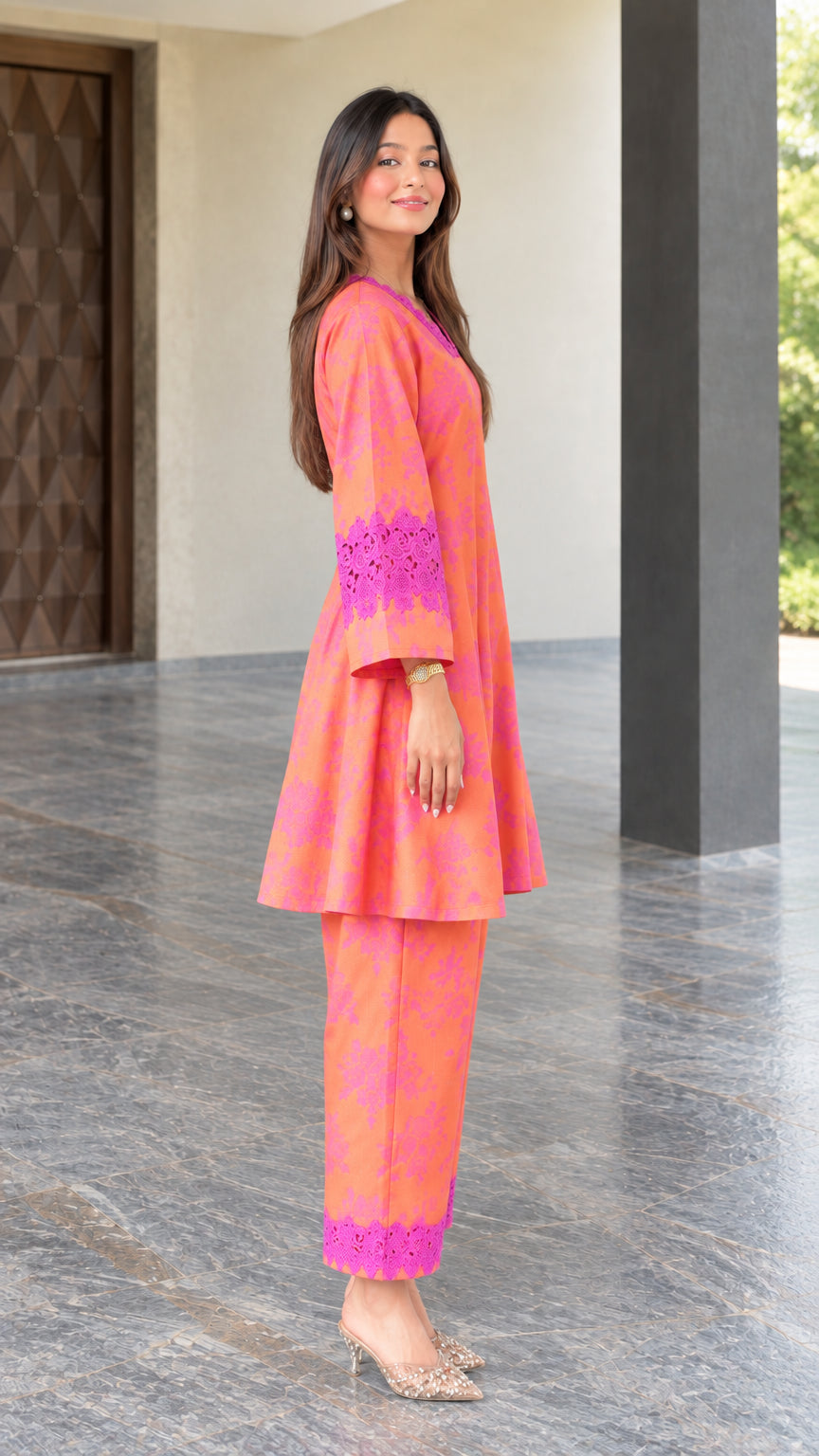 Side angle view of coral floral print two-piece tunic set