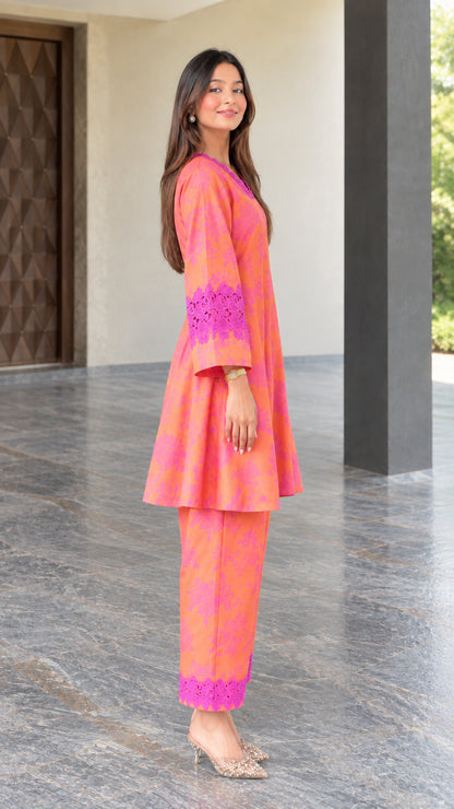 Side angle view of coral floral print two-piece tunic set