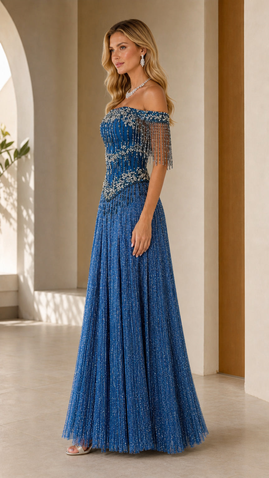 Side profile of model wearing royal blue shimmer pleated formal maxi dress