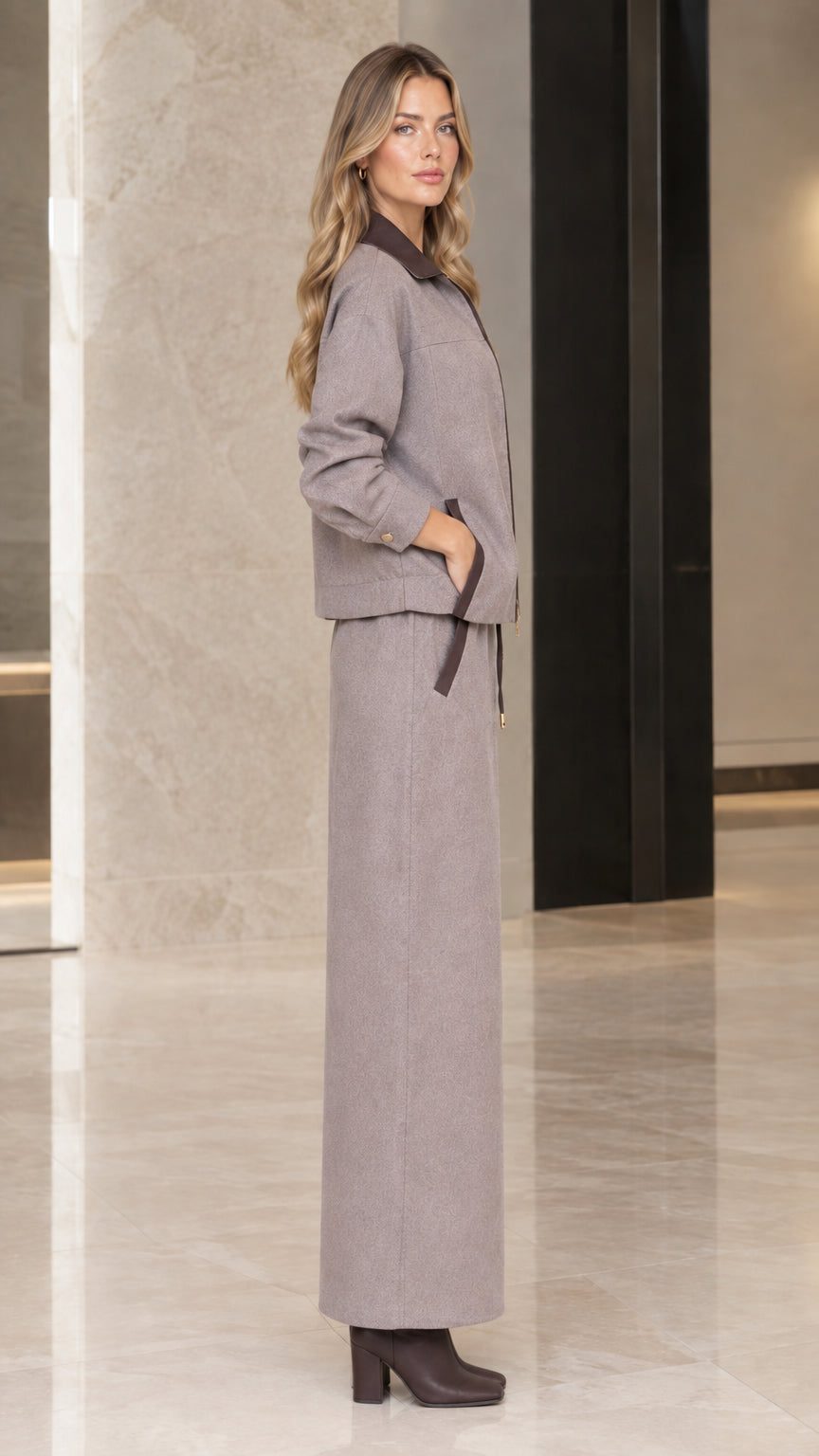 Side profile view of woman in Taupe Gray jacket and maxi skirt set