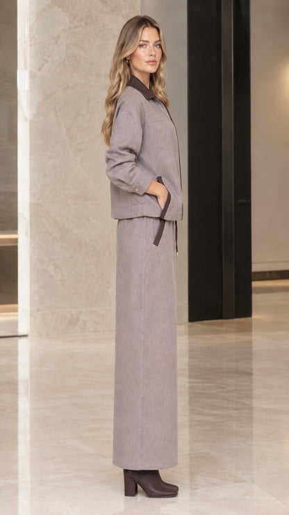 Side profile view of woman in Taupe Gray jacket and maxi skirt set