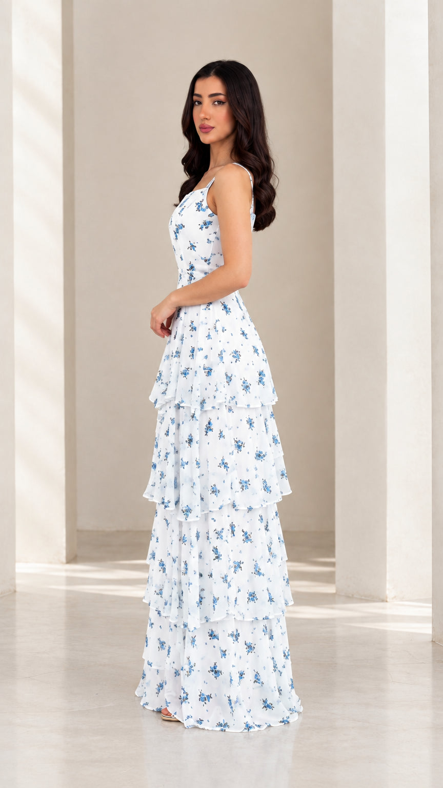 Side view of model in white floral tiered ruffle maxi dress
