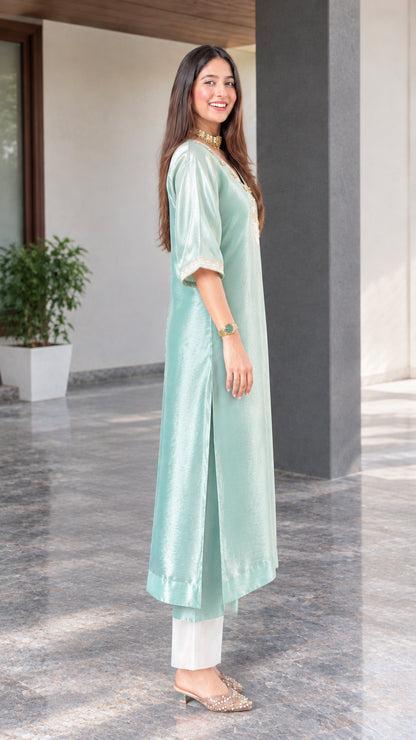 Side profile view showing side slit and drape of sage green silk blend tunic kurta