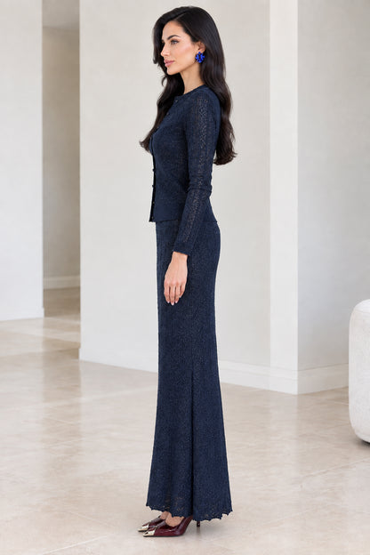 Side profile view of woman modeling navy blue knit two-piece maxi set