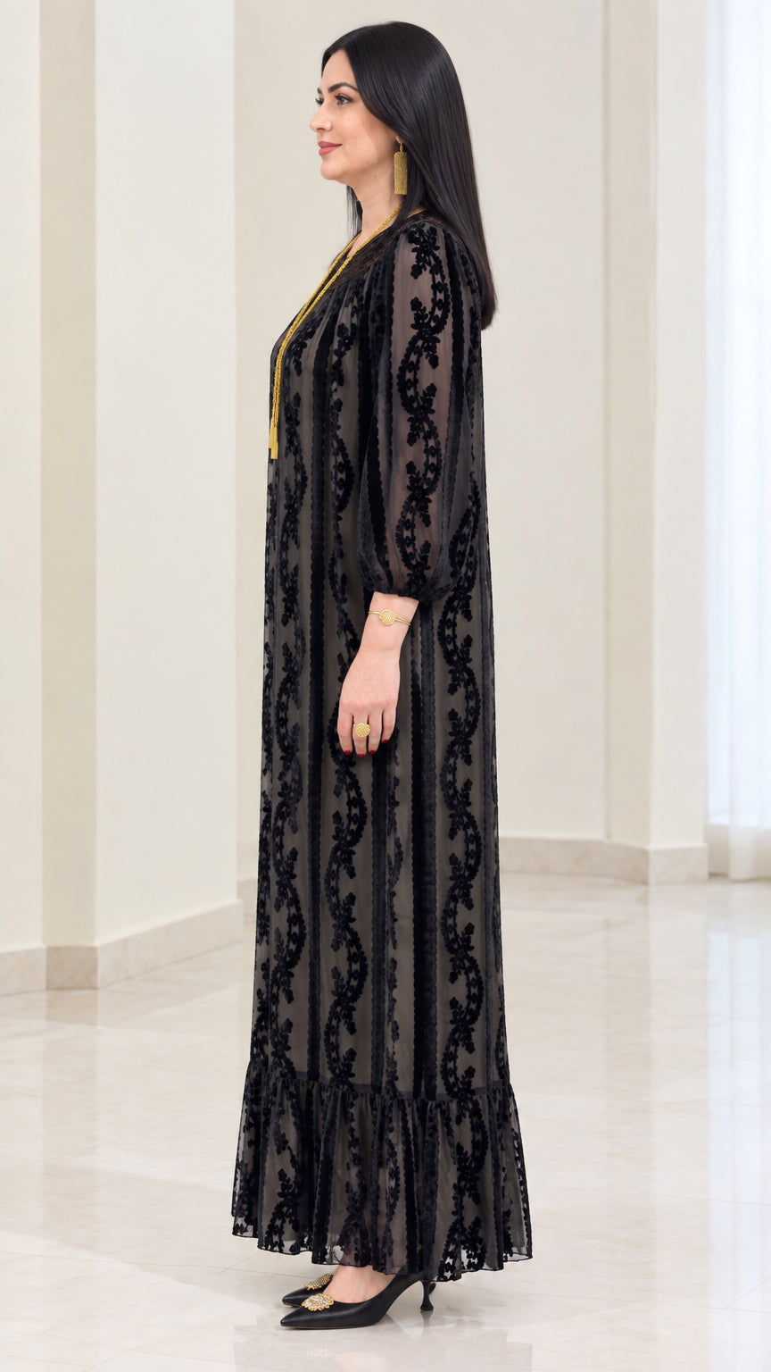 Side profile of black velvet burnout long sleeve maxi dress