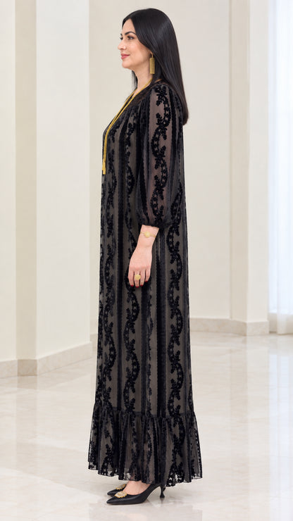Side profile of black velvet burnout long sleeve maxi dress