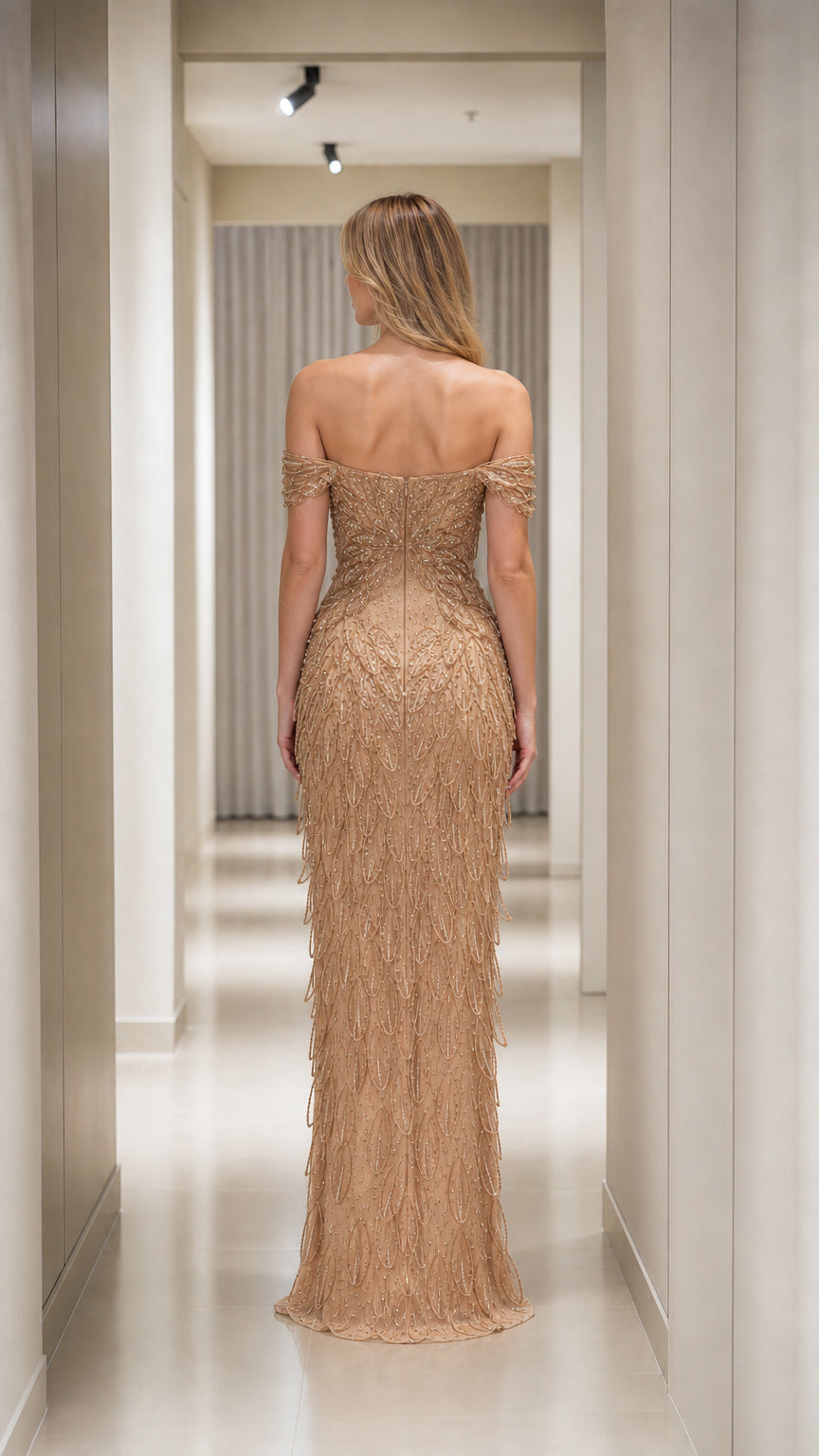 Back view of Champagne Gold fitted off-the-shoulder evening gown with sequin fringe embellishments