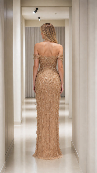 Back view of Champagne Gold fitted off-the-shoulder evening gown with sequin fringe embellishments