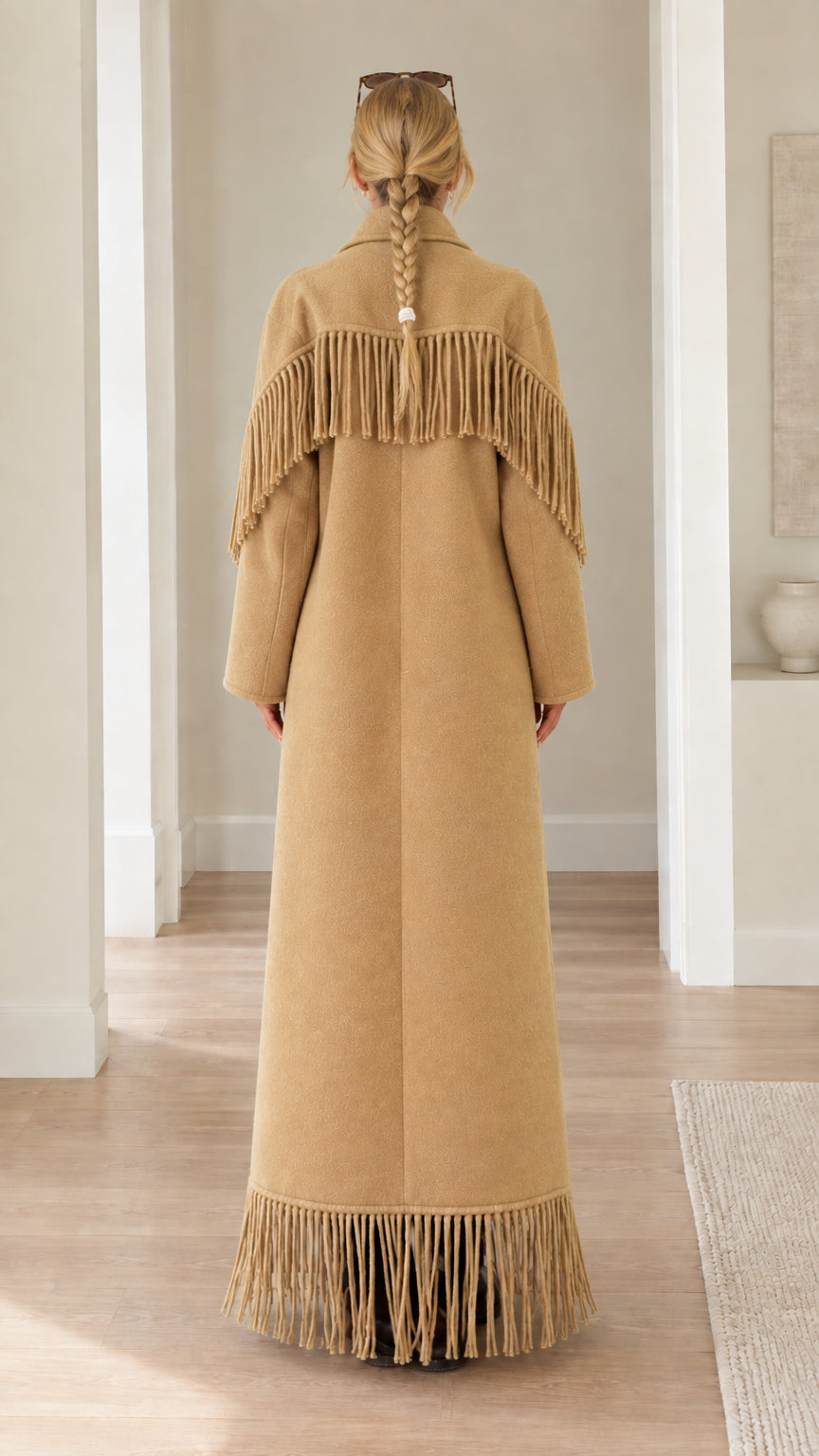 Back view of camel maxi coat highlighting fringed back yoke and hemline
