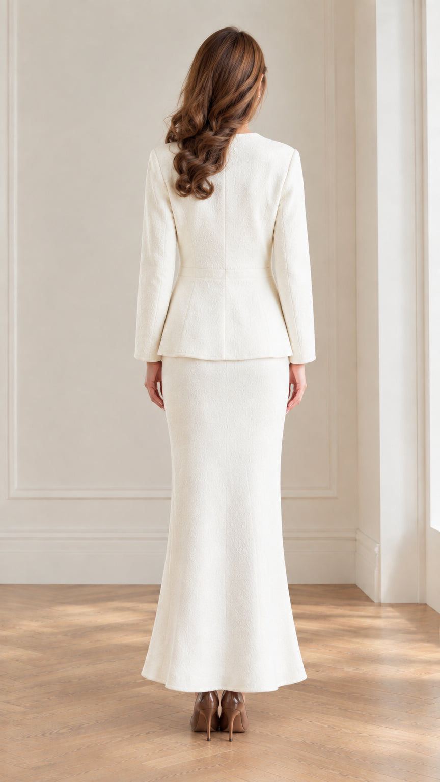 Back view of women's ivory fitted jacket and fluted maxi skirt set