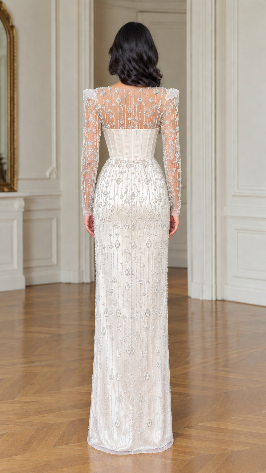 Back view of ivory illusion beaded long sleeve corset evening dress