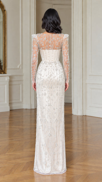Back view of ivory illusion beaded long sleeve corset evening dress