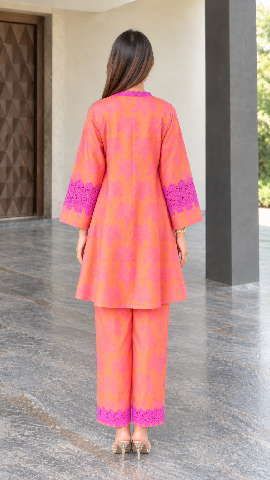 Back view of coral floral print flared tunic and matching trousers
