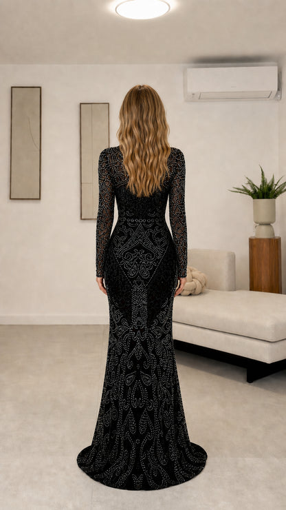 Back view of black long sleeve floor-length formal gown