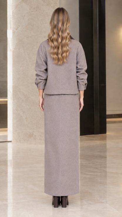 Back view of woman wearing Taupe Gray matching jacket and maxi skirt set