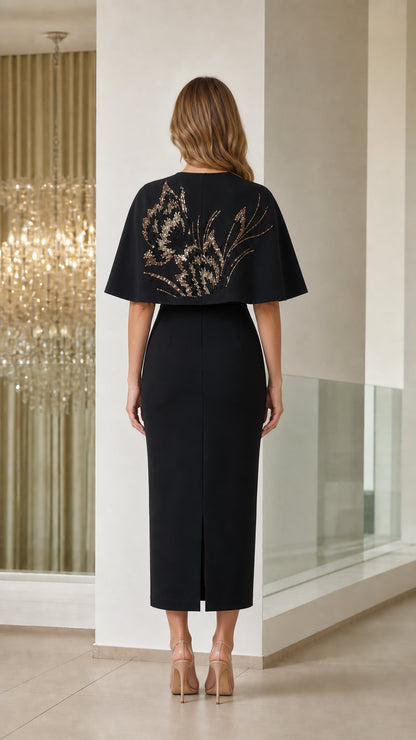 Back view of black sequined floral capelet midi dress with back slit