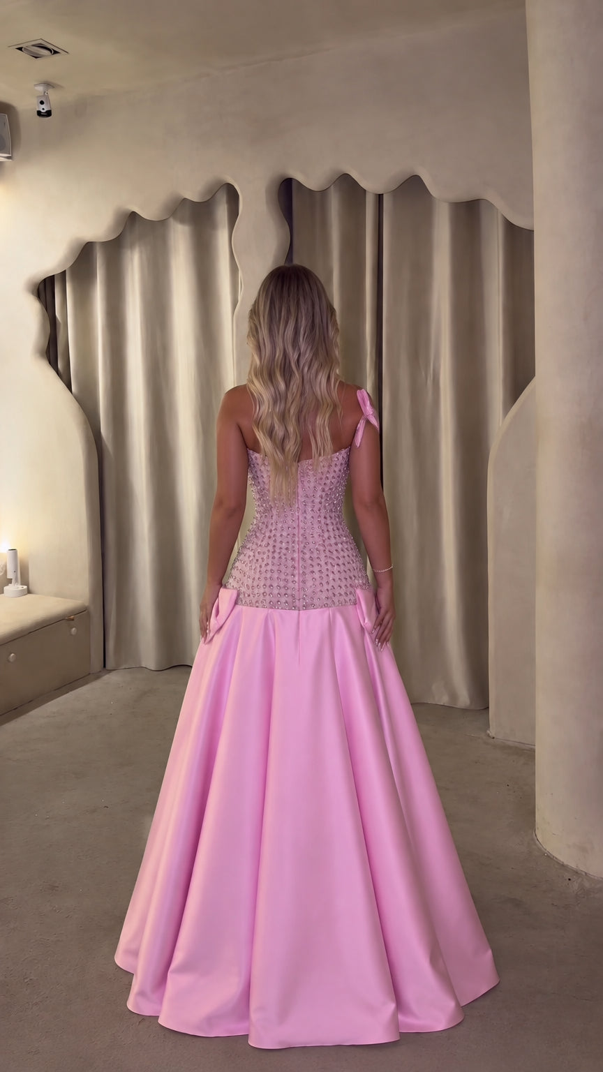 Back view of woman wearing pink sweetheart lace-trim formal gown