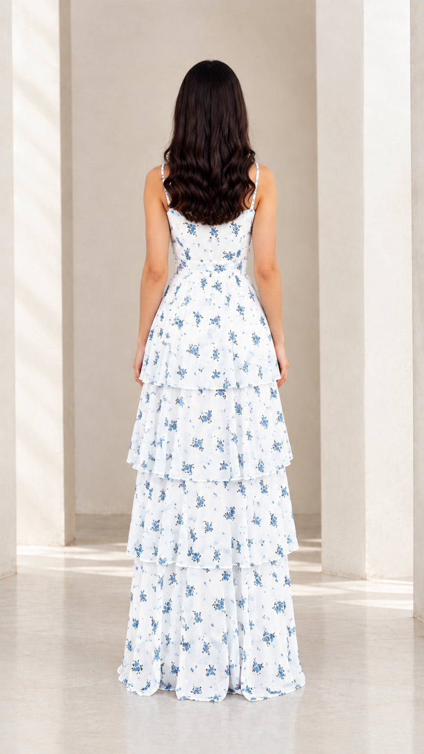 Back view of model in white floral tiered maxi dress showing strap and back detail