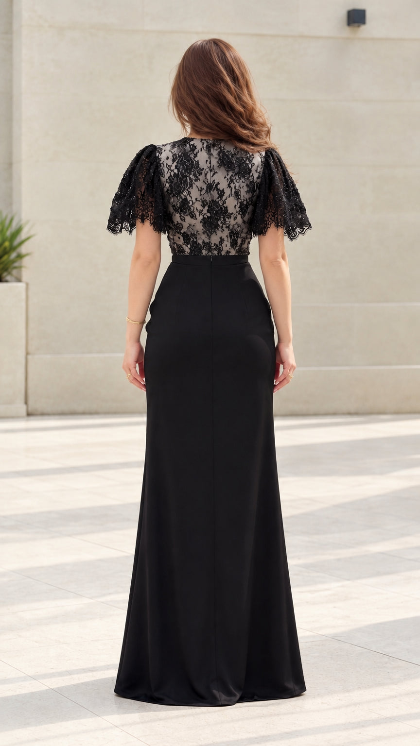 Back view of model showing lace bodice and back zipper of floor-length gown
