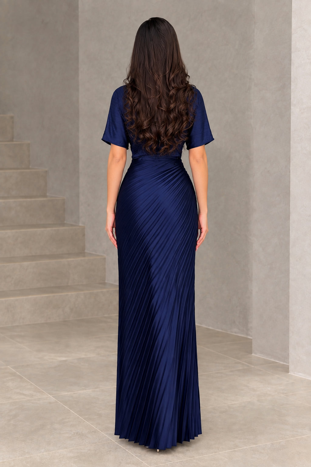 Back full-length view of navy blue pleated maxi dress